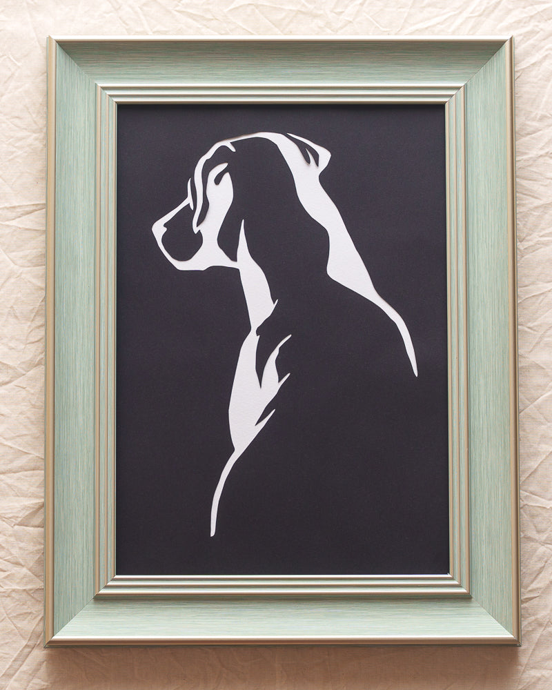 Minimalist paper cut of a Labrador's back view using simple lines