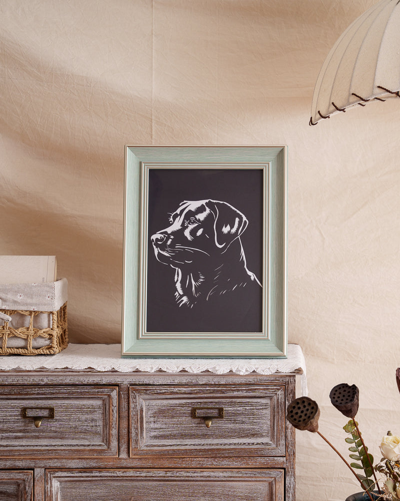Black paper-cut dog portrait displayed as home decor

