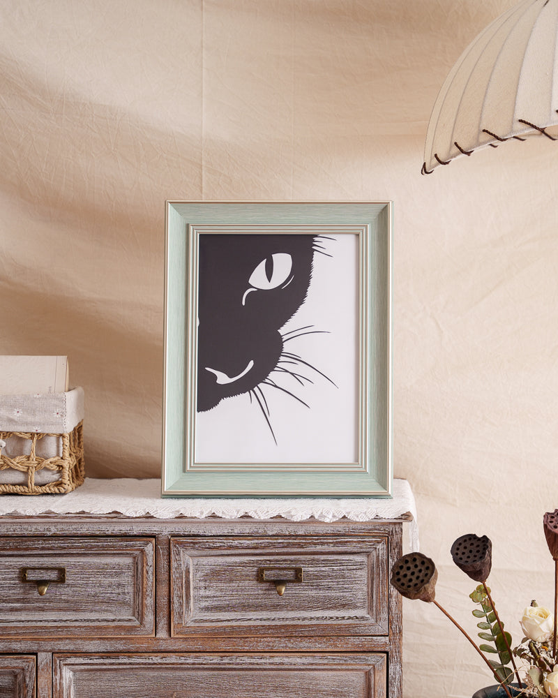 Close-up hand-cut single-layer paper art featuring a cat's head in silhouette.