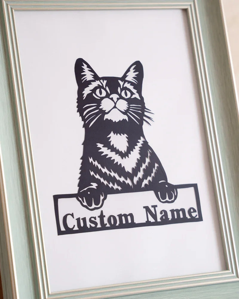 Close-up of pet's name on paper cut cat