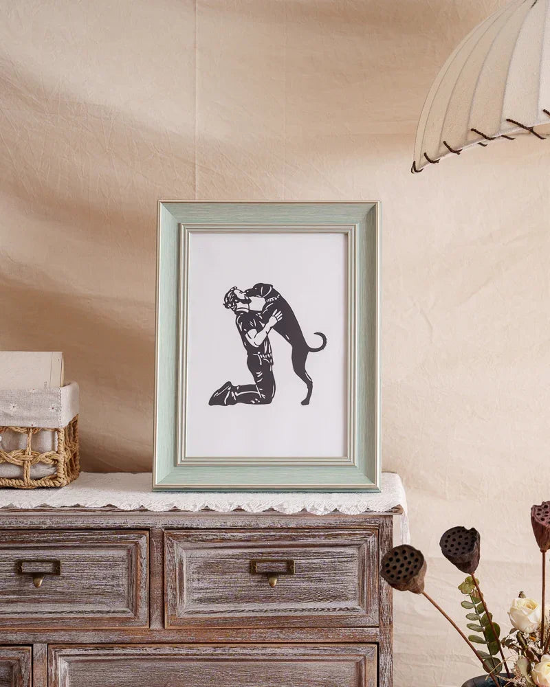A hand-cut paper art capturing a dog leaping to kiss his owner, framed as touching pet memorial gift celebrating their bond