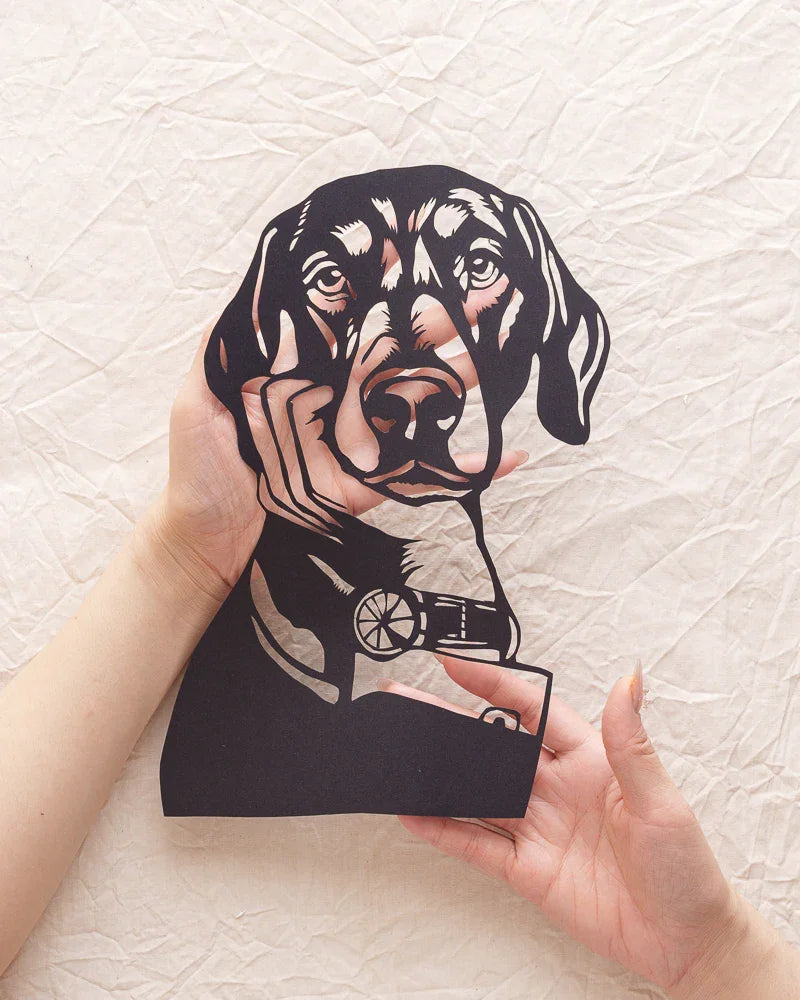 Palming this genius portrait cutout — her paper eyes still whisper when touched 