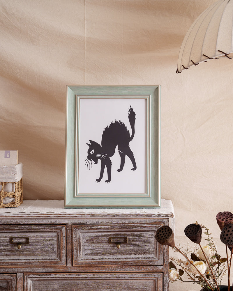 Single-layer hand-cut paper cat in mid-jump, displayed as home decoration.