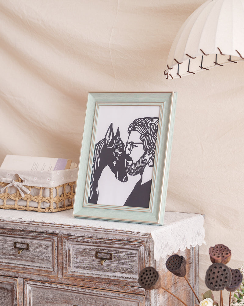 A sentimental black paper-cut memorial artwork depicting the close bond between a Doberman Pinscher and its owner, their heads touching gently.
