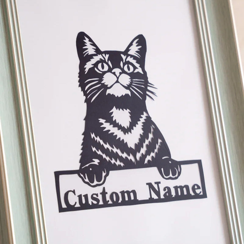 Close-up of pet's name sign on paper cut cat