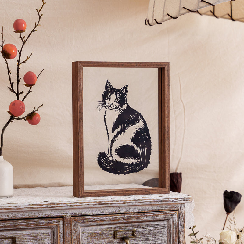 A cat papercut artwork displayed as a home decoration, adding warmth and sentimental value to the living space