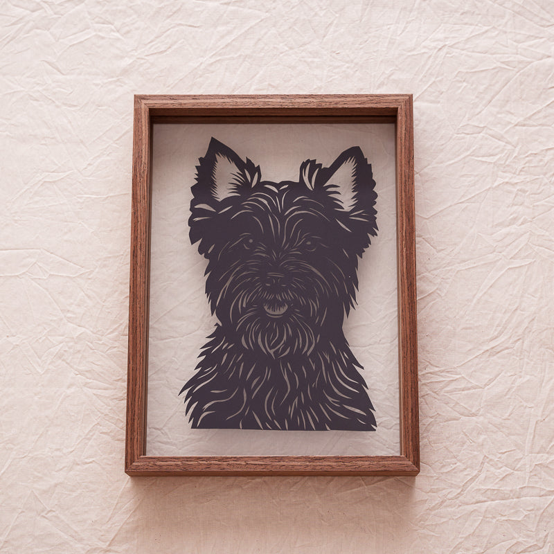 A handmade dog papercut artwork displayed at home as a heartfelt decoration to celebrate a loyal companion