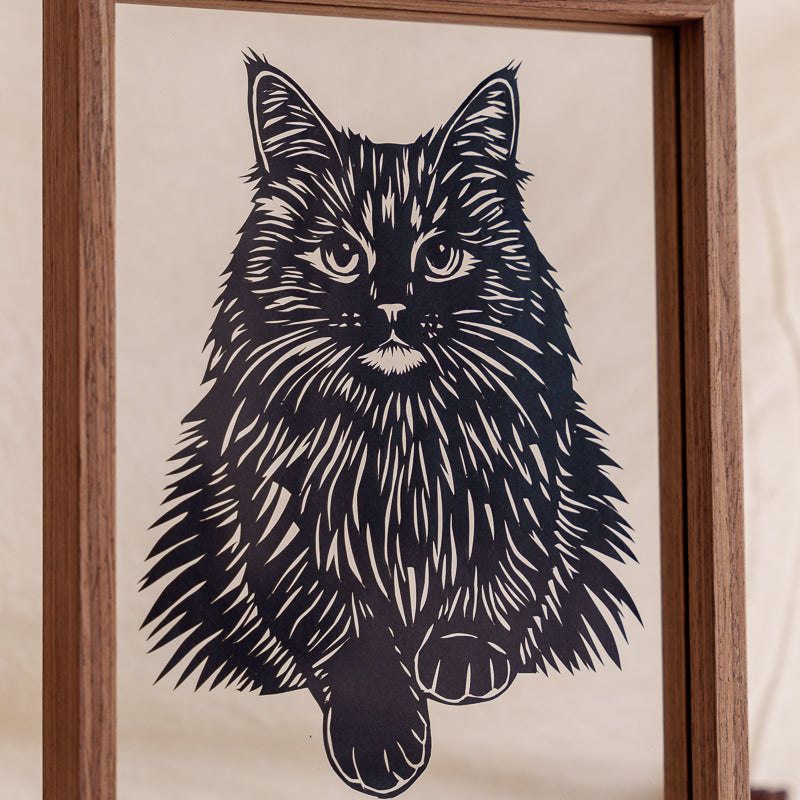 Handcrafted Maine Coon cat papercut memorial, showing exquisite carving details that replicate the cat’s soft fur textures.