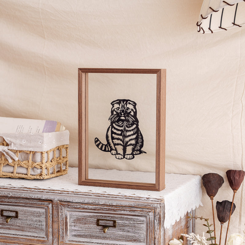 Cat silhouette papercut memorial displayed as a home decoration, perfectly capturing the cat’s downcast and sorrowful expression.