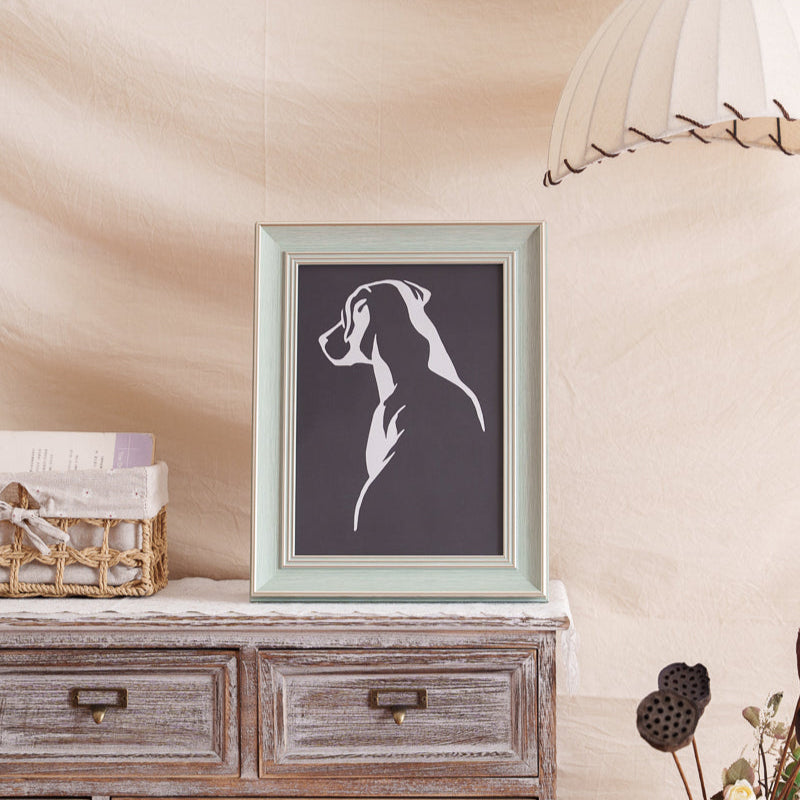 Framed dog memorial paper cut, displayed at home as a keepsake