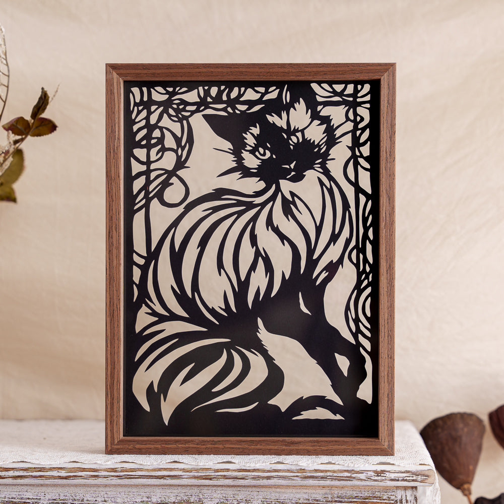 The memorial papercut captures the moment of a cat sitting on the windowsill, showing off its graceful curves.
