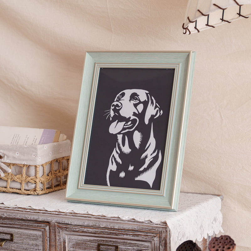 dog memorial portrait paper cut displayed at home.
