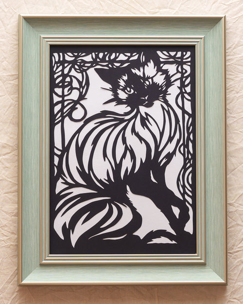 Artistic paper cut of a cat with flowing curves and decorative window patterns, created as a heartfelt memorial