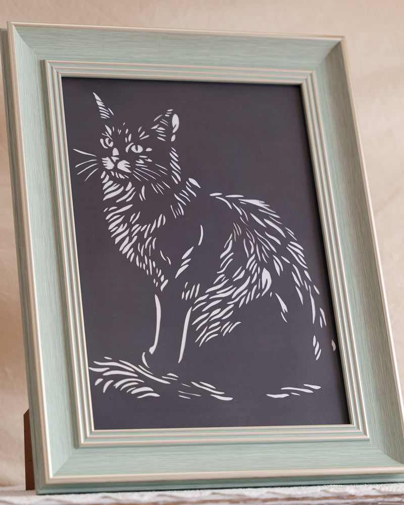 Cat paper cut showing intricate fur detail with hand-cut precision

