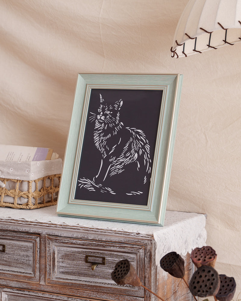Pet cat silhouette paper cut memorial displayed at home

