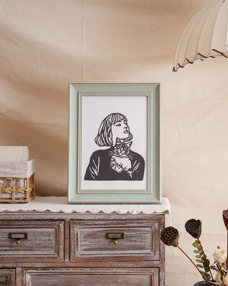 A custom-made, hand-cut paper art piece for home decoration, featuring a lady holding a kitten