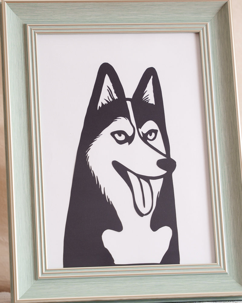 Closeup of hand-cut details showing husky's fur direction and ear contours on paper edge