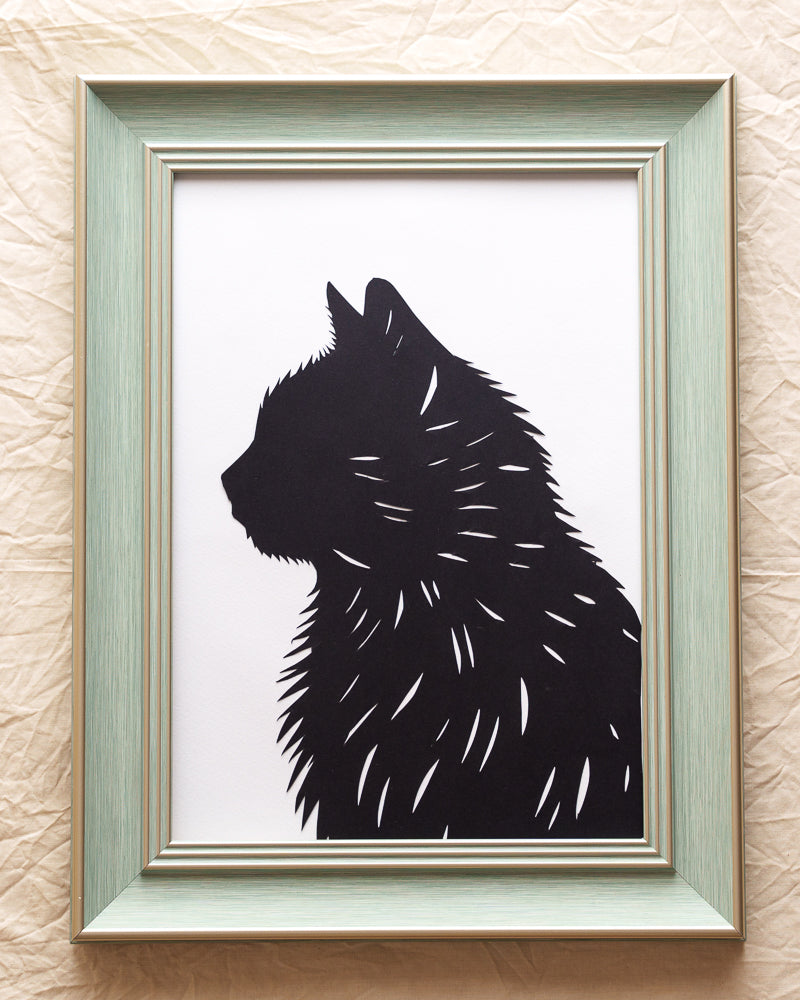 A custom silhouette portrait artwork of a black cat