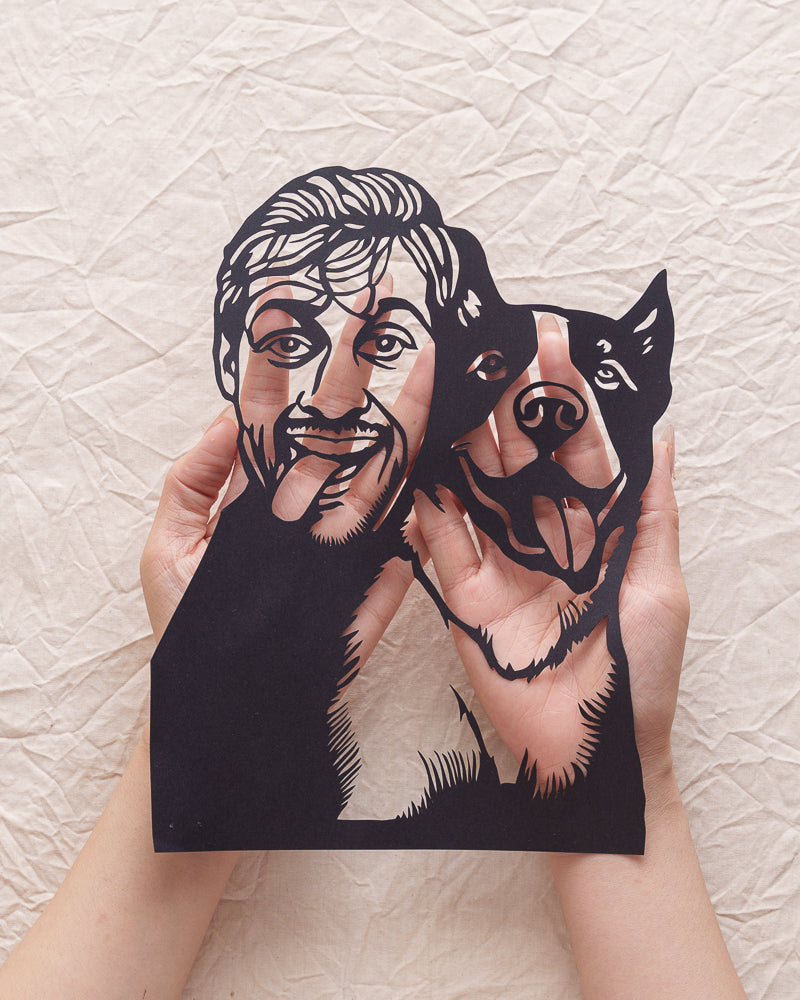 Hands cradling personalized shadow silhouette of owner and pet with backlight glow effect