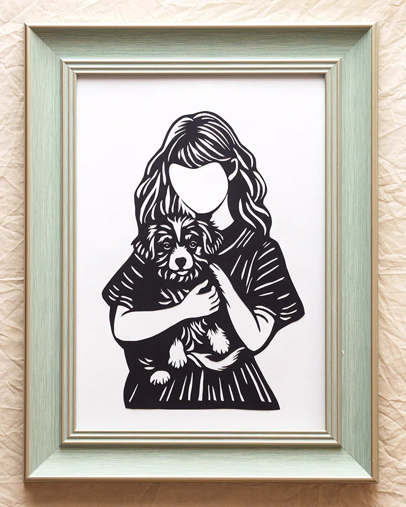 paper cut art: Little girl cuddling her pup in silhouette