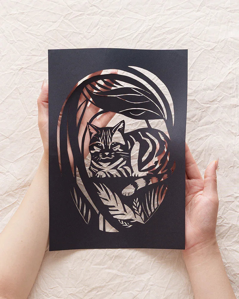 Holding my cat's garden memorial paper-cut right here in my hands 