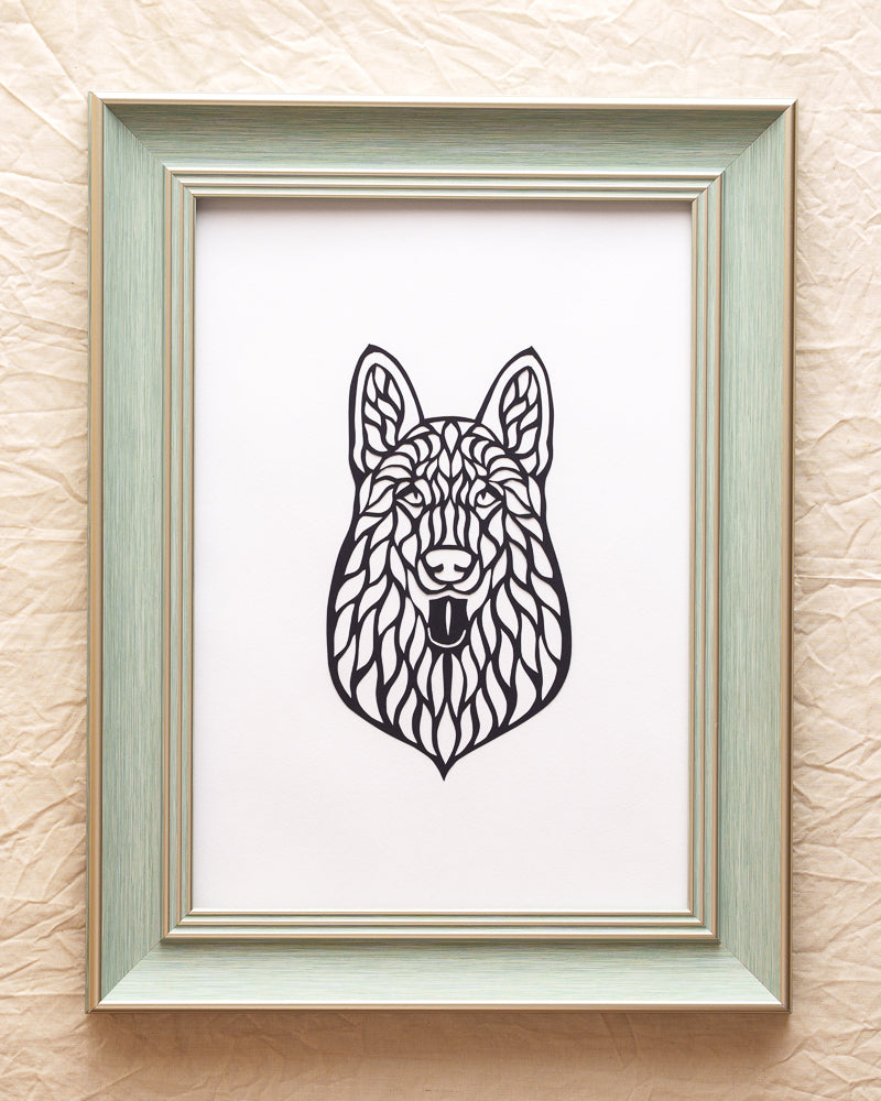 A striking hollowed-out paper-cut artwork featuring a detailed ​​frontal view portrait​​ of a Husky dog, capturing its expressive eyes and symmetrical features. 