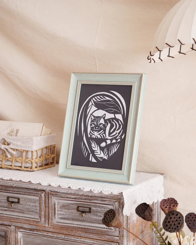 Picked this garden hide-and-seek photo of my cat for the paper-cut artwork, and now it's displayed at home