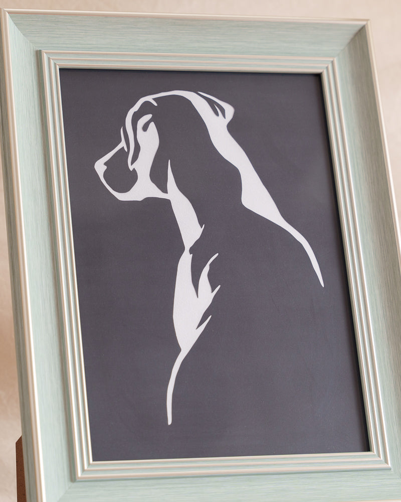 Paper cut artwork recreating the back view of a Labrador with clean lines