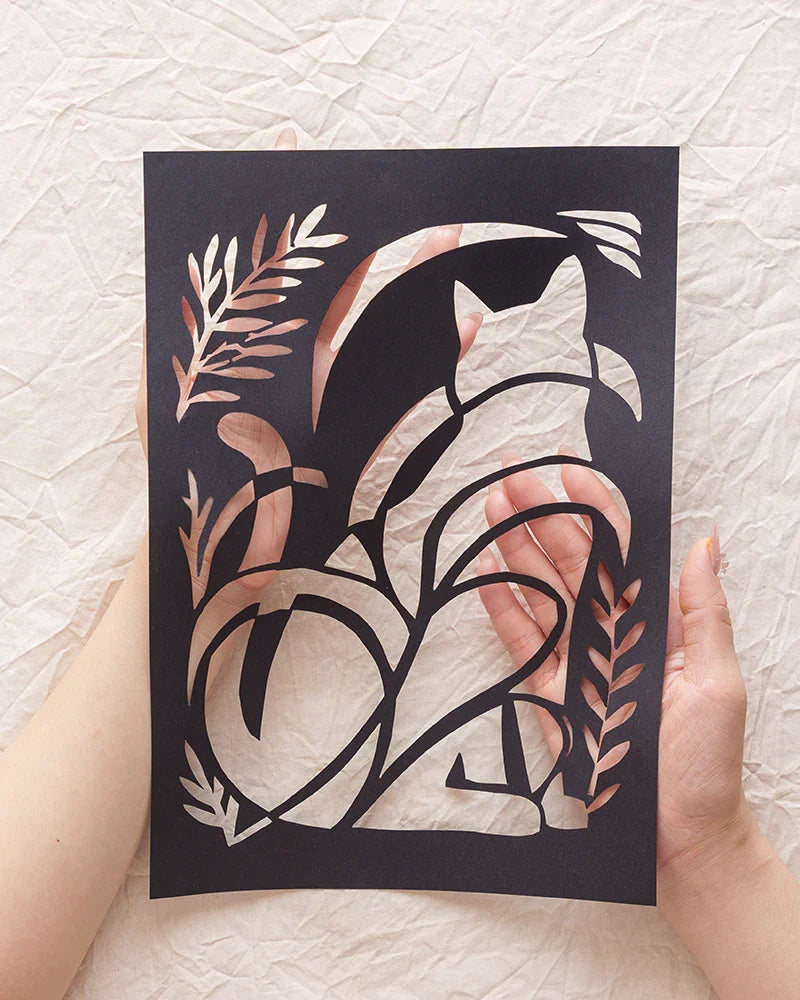 Holding my cat's memory catcher — this abstract silhouette paper-cut — right in my hands.