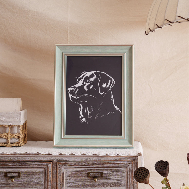 Black paper-cut dog portrait displayed as home decor
