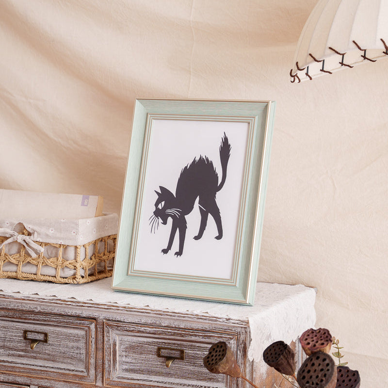 Cat paper cut displayed on a shelf, perfect for commemorating a beloved cat.