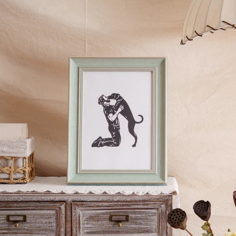 A hand-cut paper art capturing a dog leaping to kiss his owner, framed as touching pet memorial gift celebrating their bond