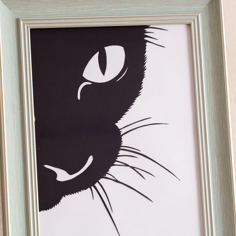 Hand-cut single-layer cat silhouette paper art showcasing intricate whisker details.