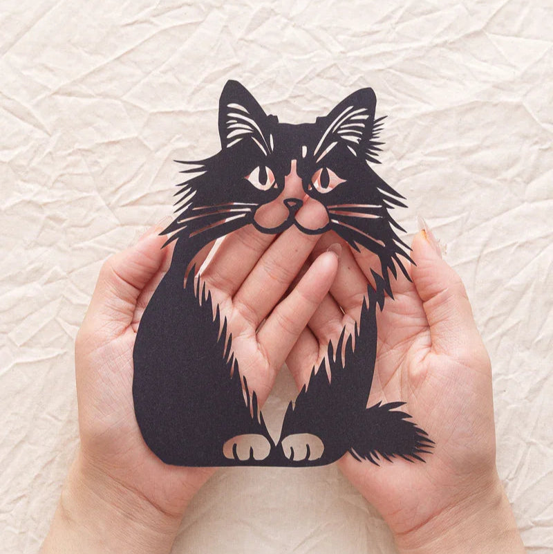 Palm-sized but love-oversized: Her life-like fur strands hand-snipped so crisply, I still feel phantom purrs when tracing paper-ridges