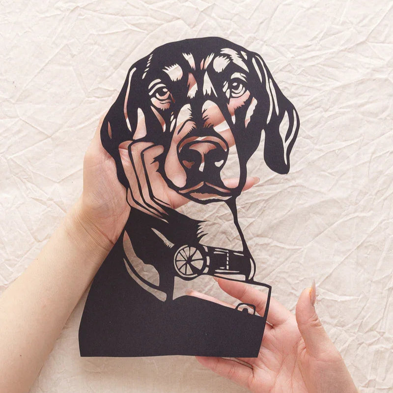 Palming this genius portrait cutout — her paper eyes still whisper when touched 