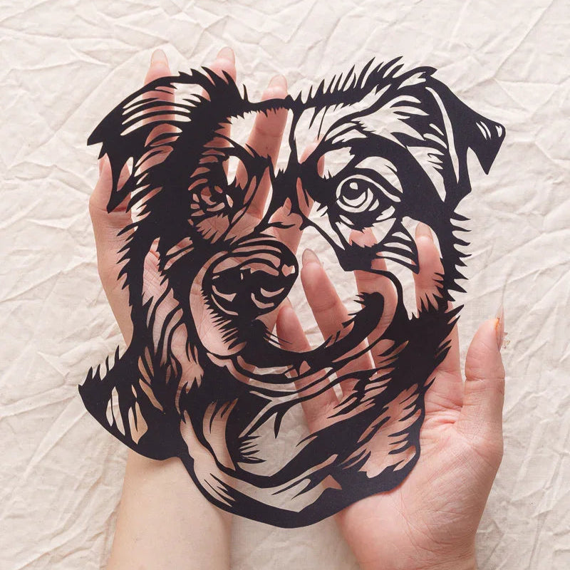 Cradling your dog's paper-cut portrait, fingertips find every lifelike fur ridge and nose wrinkle