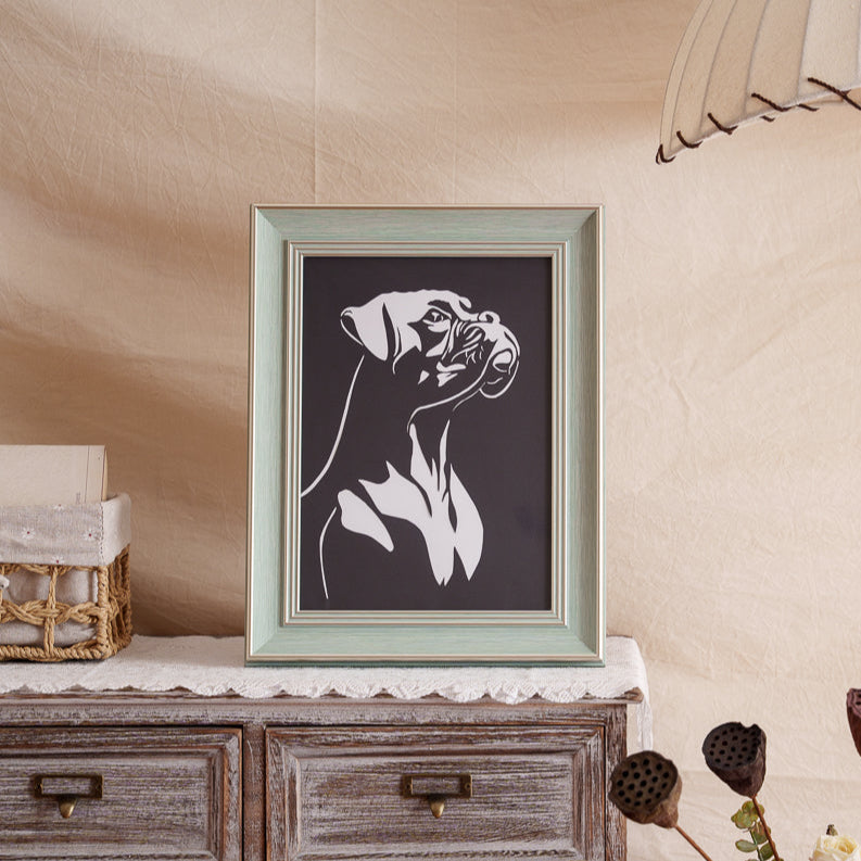 His framed paper spirit now guards the fireplace mantel — forever standing watch where sunbeams warm his spot daily 