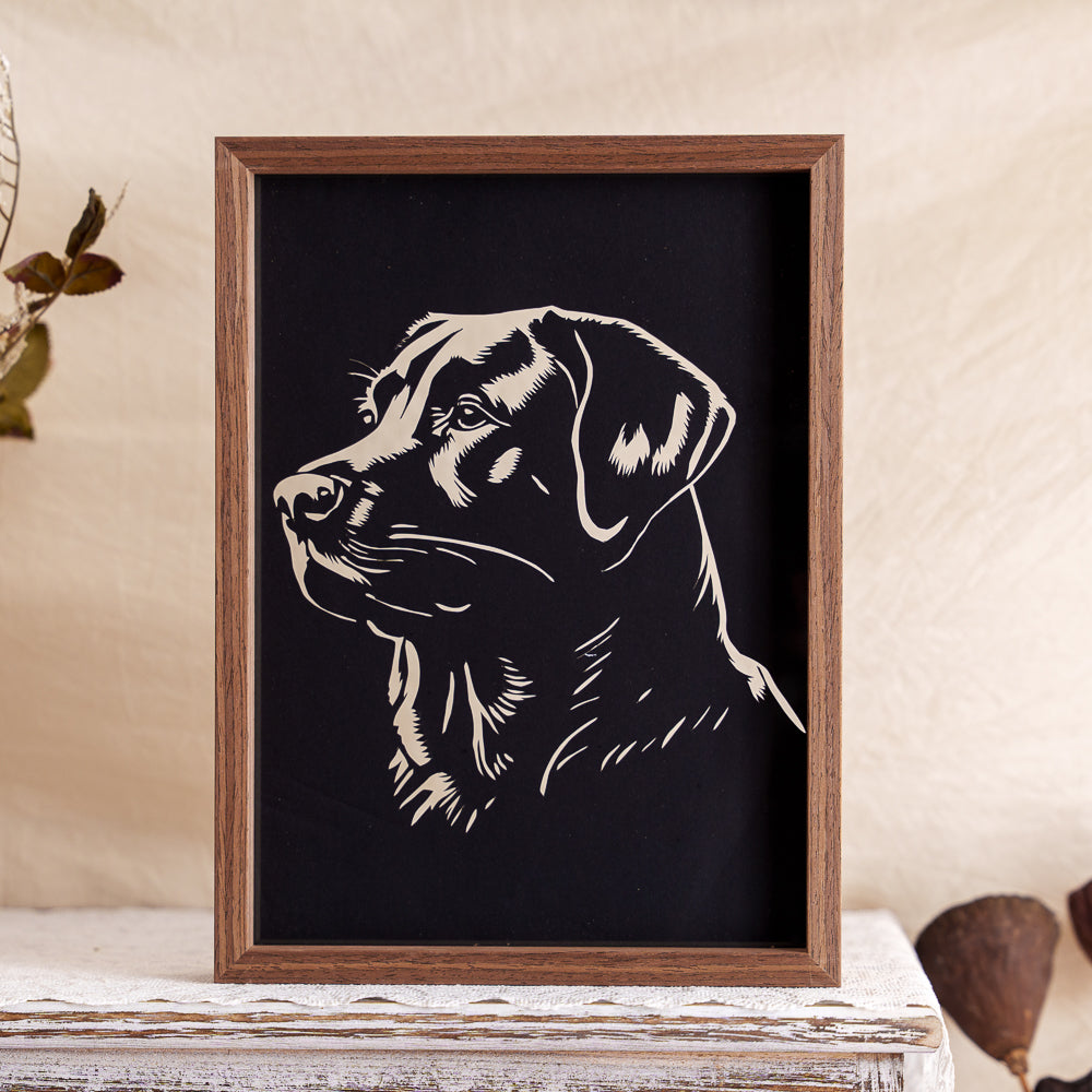 A simple yet powerful black silhouette papercut of a Labrador, honoring the loyal and gentle spirit of this beloved companion.