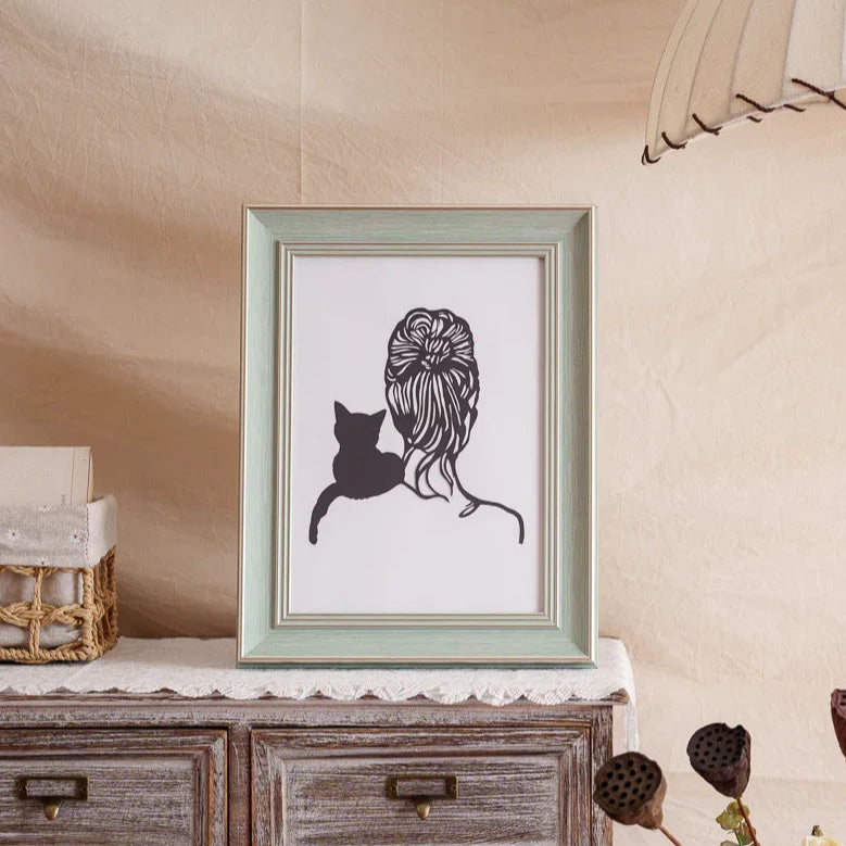 A hand-cut paper artwork showing a cat perched contentedly on its owner's shoulder, paper-thin whiskers catching light as they lean into each other—forever capturing a daily moment of cherished bond