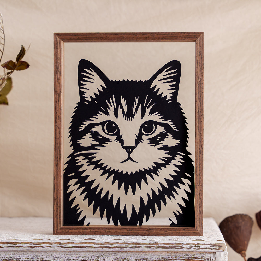 A finely crafted memorial papercut featuring a symmetrical portrait of a cat, highlighting its calm expression and balanced beauty through mirrored design.