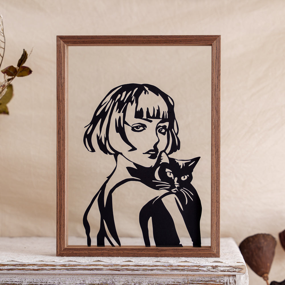 A touching papercut artwork featuring a woman holding her cat, both turning back to share a quiet, loving gaze — a timeless moment of companionship.