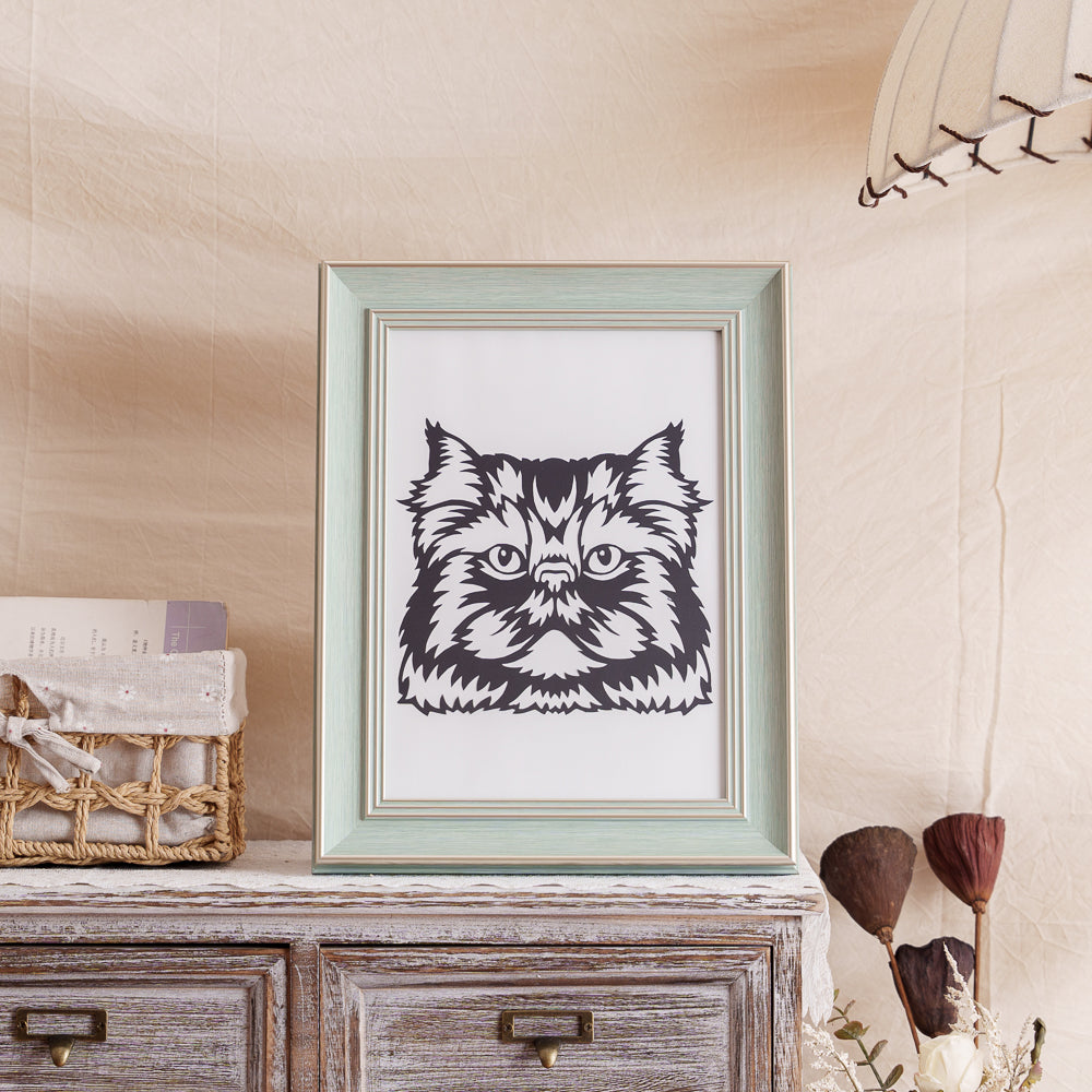 Framed cat memorial silhouette paper cut displayed on a shelf as home decor