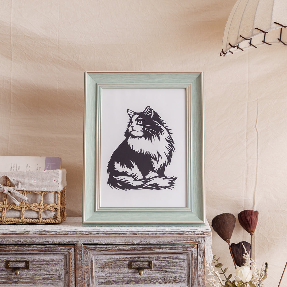 Cat memorial paper cut artwork displayed at home as a decorative piece.
