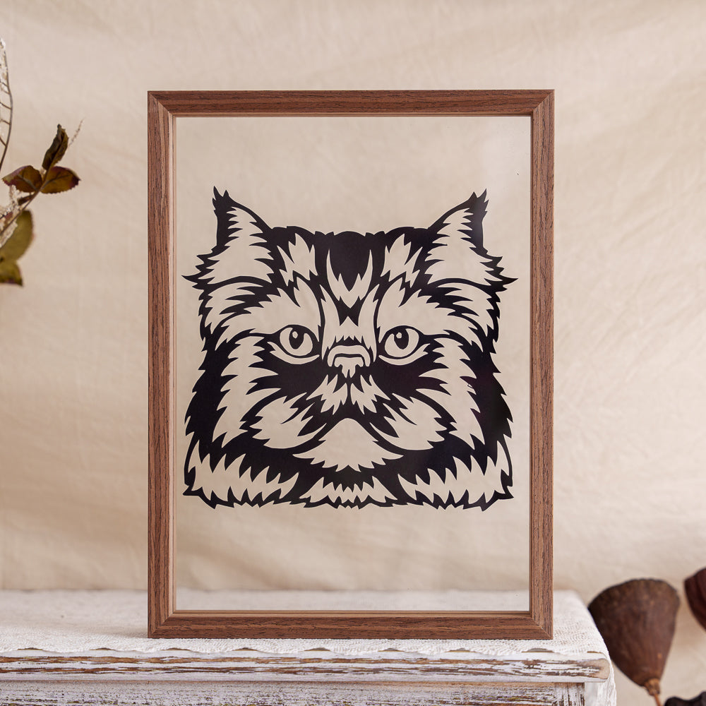 A black cat portrait silhouette, hand-carved to capture the cat's unique expression and features.