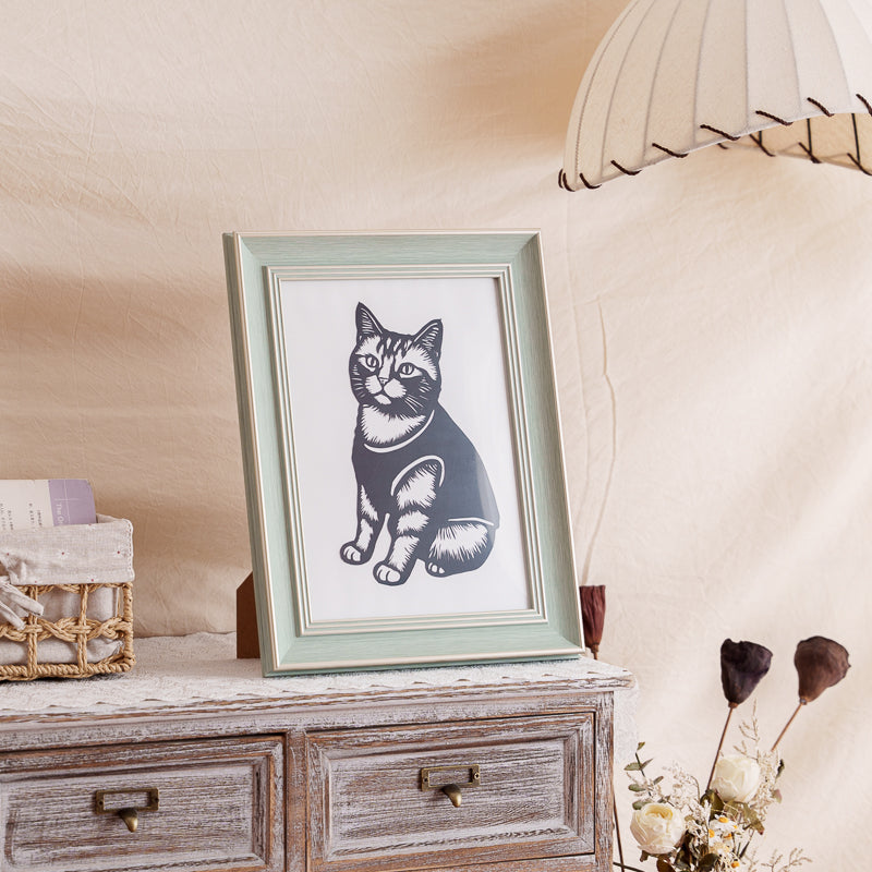 A black cat silhouette papercut displayed on a shelf as home decor.