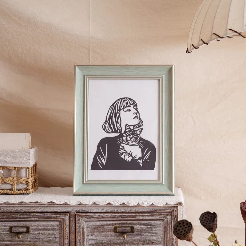 A custom-made, hand-cut paper art piece for home decoration, featuring a lady holding a kitten