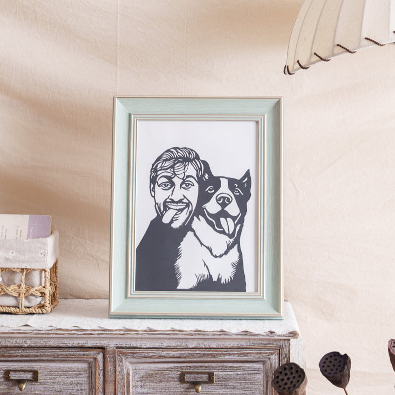 Framed pet-owner silhouette memorial displayed on living room shelf with natural wood accents