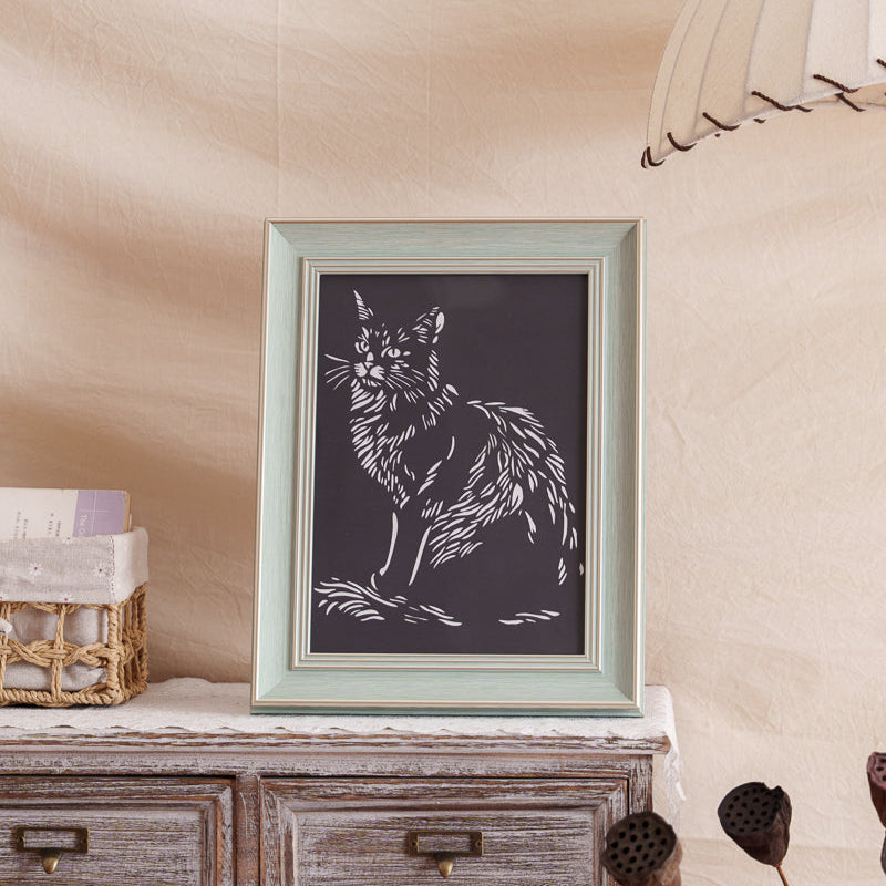 A custom cat portrait paper cut memorial displayed at home