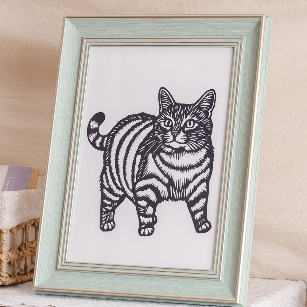 A detailed cat silhouette paper cut artwork framed and ready for display