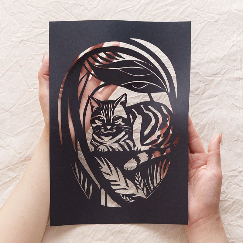 Holding my cat's garden memorial paper-cut right here in my hands 